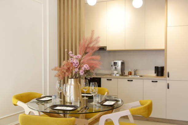 istock Dining table in the kitchen with pink flowers bouquet in the vase 2042521955