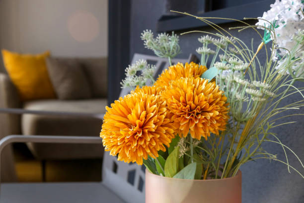 istock Nice orange flowers in vase on the balcony table, home decor concept 2042521961