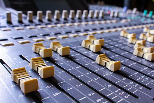Old mixing console with worn faders