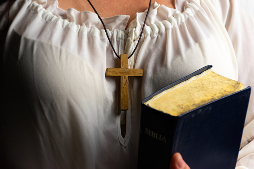 Cross in a neck and holy bible