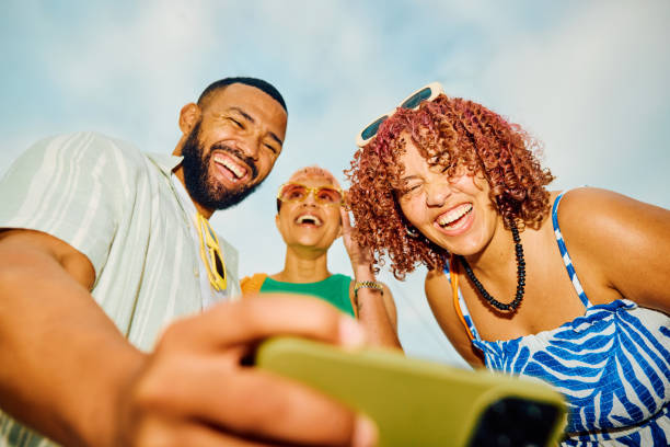 istock Happy group of friends using their smartphone while travelling. 2042539283