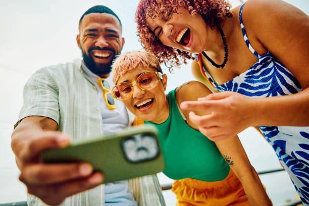 istock Happy group of friends using their smartphone while travelling. 2042539292