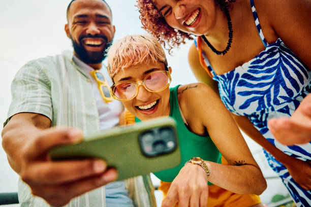 istock Happy group of friends using their smartphone while travelling. 2042539306