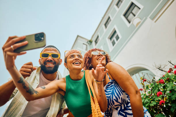 istock Happy group of friends using their smartphone while travelling. 2042539329