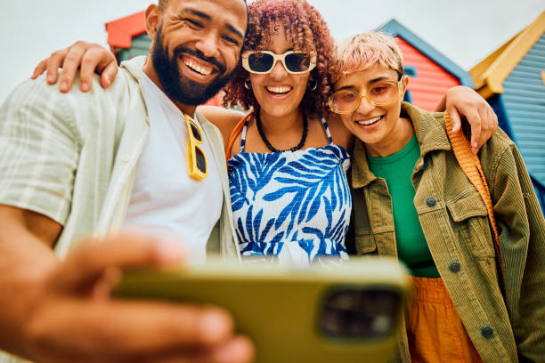 istock Happy group of friends using their smartphone while travelling. 2042539858