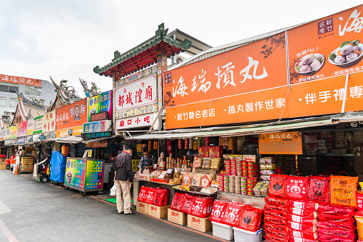 Hsinchu City, Taiwan- November 8, 2023: The market in front of the God Temple (Cheng Huang Temple) in Hsinchu City, Taiwan. There are many stalls selling delicious Taiwanese snacks.