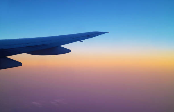 istock Stunning sunrise sky with airplane wing seen from plane window during flight 2042560229