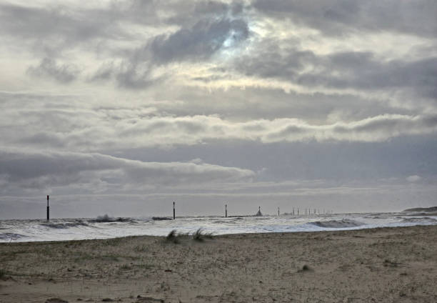 view over wind swept beach to the sea\n\nEccles-on-Sea, Norfolk, UK.        February