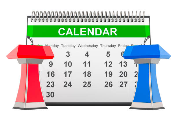 Blank paper desk calendar with blank yellow sticky note on a wooden shelf against dark concrete wall with copy space.