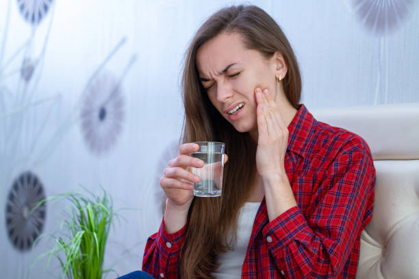 istock Young woman suffering and experiencing strong aching toothache. Tooth decay and sensitivity. Diseases gums 2042604687