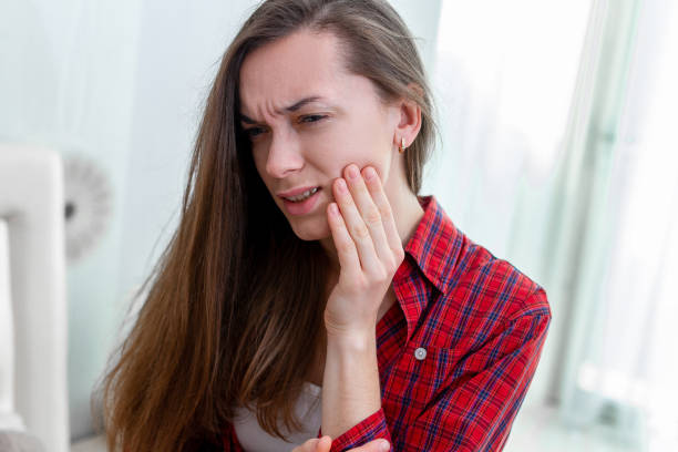 istock Young woman suffering and experiencing strong aching toothache. Tooth decay and sensitivity. Diseases gums 2042604938