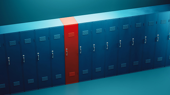 Locker room full of blue lockers, but one stands out and it is red. Concept of being different, individuality and making the right choice.