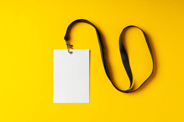 istock Blank nametag on a string on yellow background copy space 2042624217