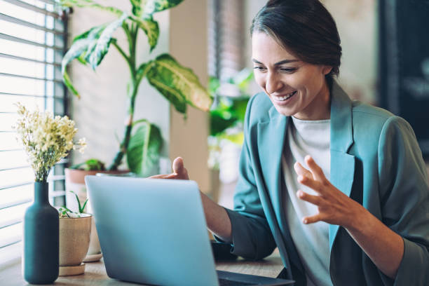 istock Smiling businesswoman having a video connection 2042631751