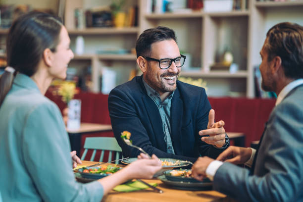 istock Business persons having friendly and casual conversation during dinner 2042631752