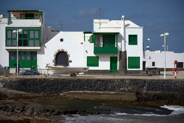 Typical house in the port. Caleta de Famara (Spain), January 21, 2024.  This town is a place on the Canary coast preferred by surfers due to the strong wind and big waves. caleta de famara lanzarote stock pictures, royalty-free photos & images