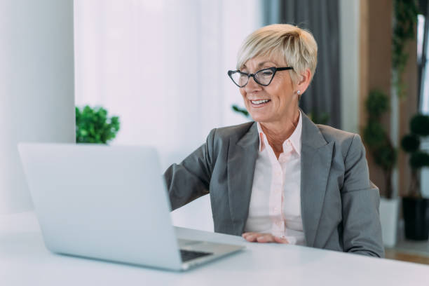 istock Successful businesswoman in modern office working on laptop. 2042651798