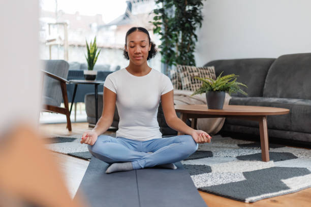 istock Young Woman Practicing Meditation at Home 2042654525