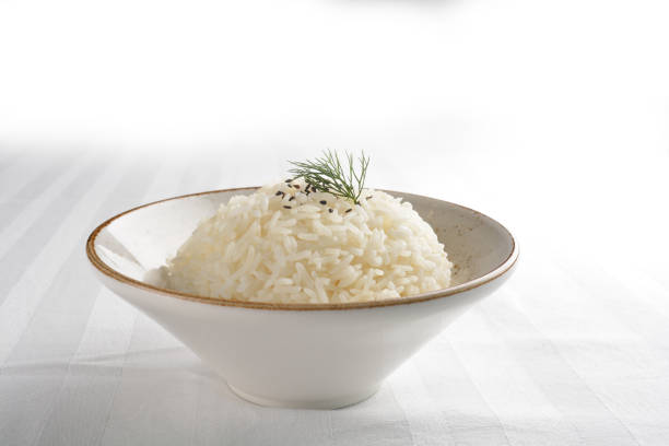 steamed fragrant white jasmine rice in Japanese ceramic bowl on white table restaurant asian cafe chinese banquet halal menu