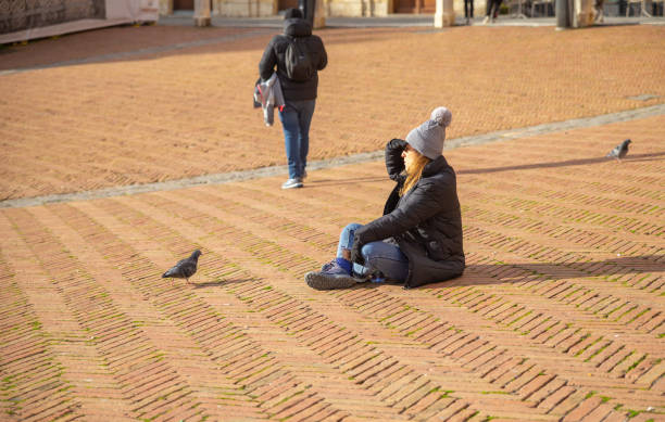 Siena, Italy–Jan 08, 2024: tourists walking on the street during sunset