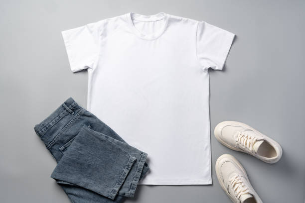 istock T-shirt, jeans and white sneakers on gray background top view 2042664340