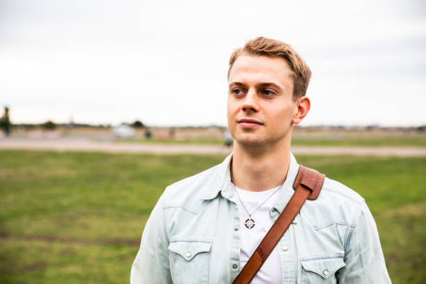 istock Caucasian young man portrait at park 2042665387