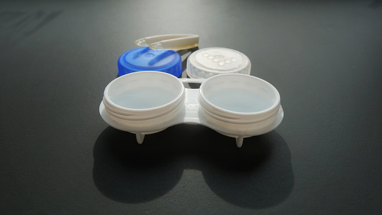 Optical Companion: Container and Tweezers for Lenses.