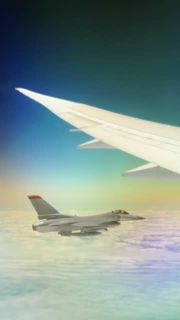 Fighter jet flying beside a passenger jet.
