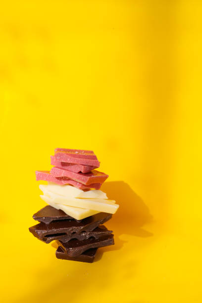 istock colorful chocolate pieces on a bright background 2042689412