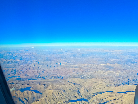 View from the airplane window mid air, above Iran.
