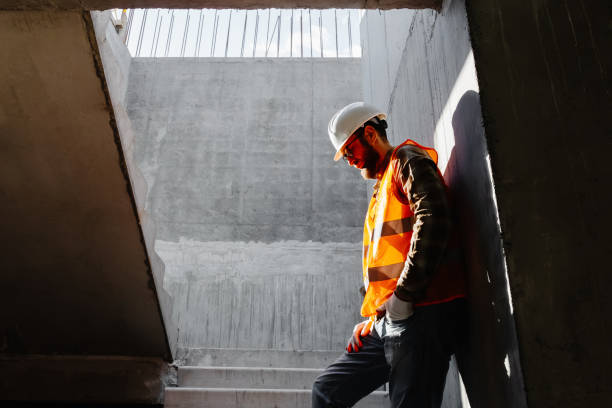 Young businessman construction standing on his workplace on the construction site.