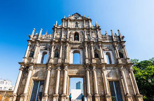 Macau- September 20, 2019: Tourists visit the Ruins facade of St.Paul's Cathedral in Macau, a historic architectural landmark of Macau. The place is one of the UNESCO World Heritage.