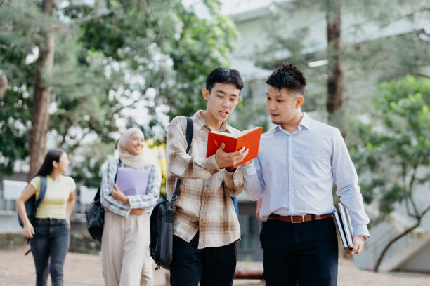 istock Asian student and professor walking and talking in university campus 2042719601