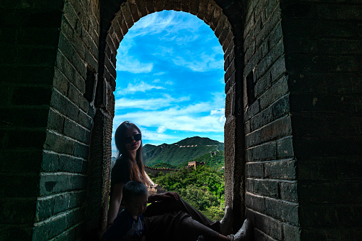 A beautiful lady is playing on the Great Wall