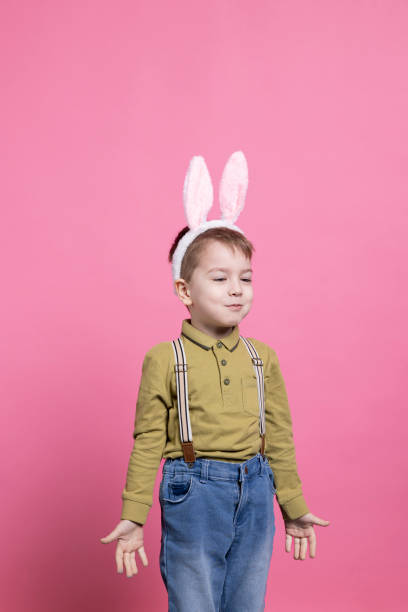 istock Small boy wearing bunny ears in front of the camera 2042720853