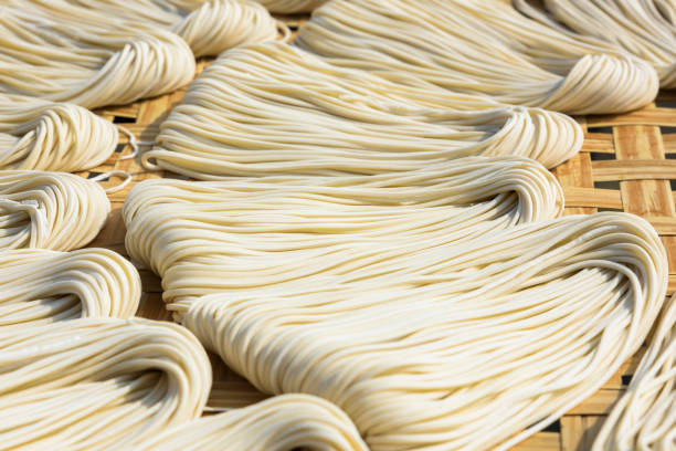 Stack of uncooked dry yellow noodles