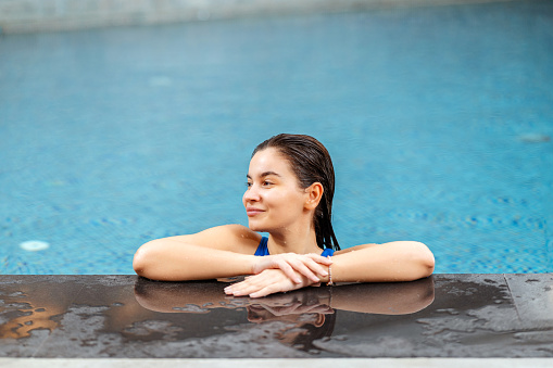 Woman by the swimming pool