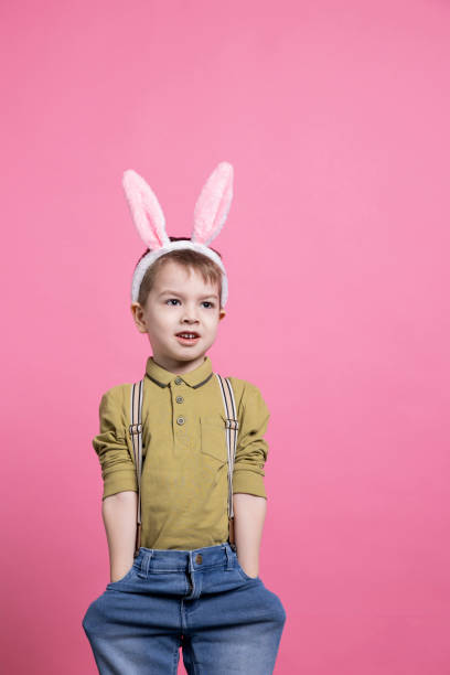 istock Young adorable boy smiling and standing over pink backdrop 2042721366