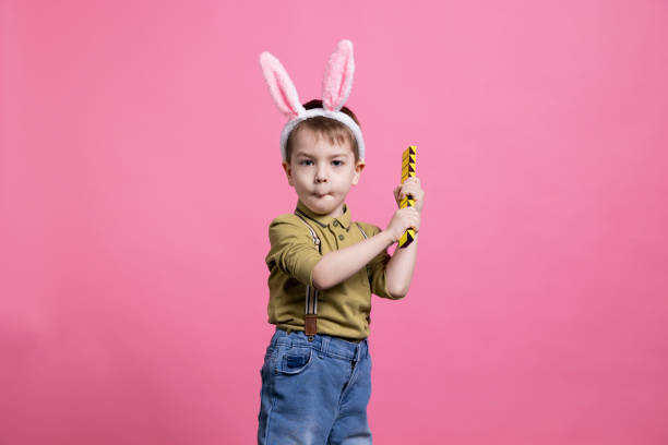 istock Happy smiling young kid playing with a plastic toy in studio 2042722023