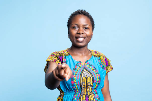istock African american model pointing index finger at camera over blue background 2042738779