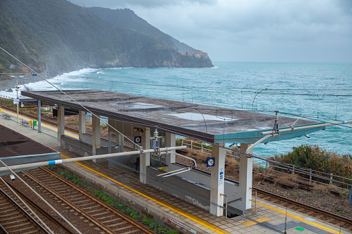 Overlook of the coastal railway track and platform with sea