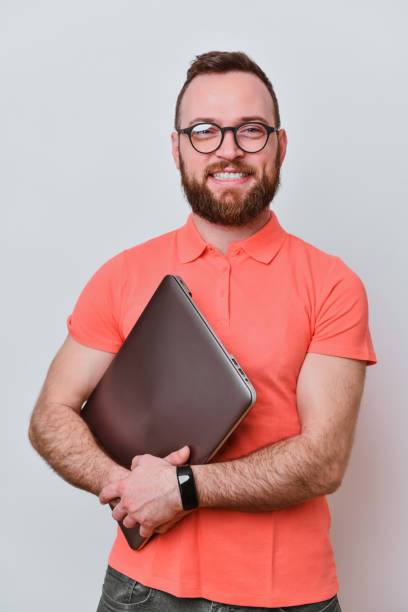 istock Smiling Male IT Tech And His Laptop 2042757265