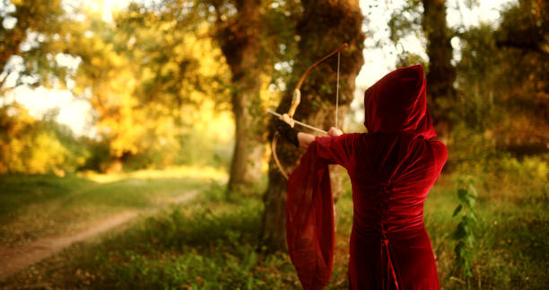 istock Magical Woman With A Bow And Arrow In The Forest 2042764265