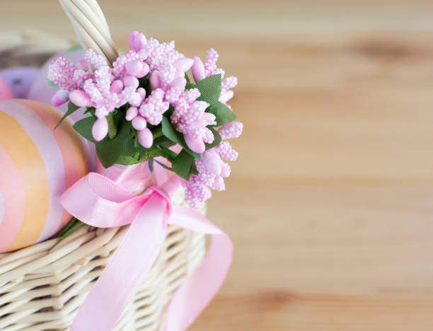 istock Easter card, wicker basket with easter eggs and decoration with bow, selective focus 2042779776