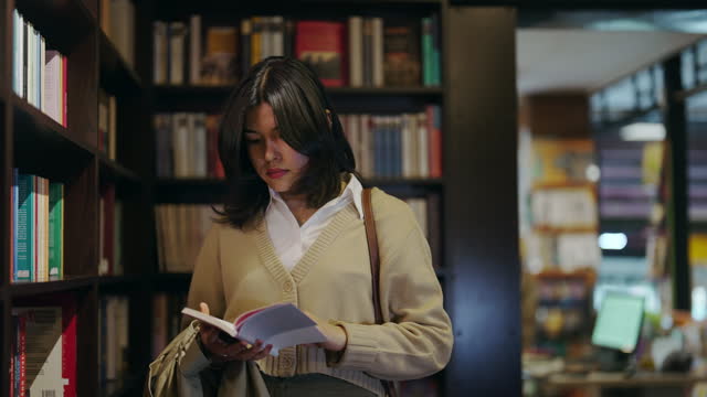 Woman looking the bookshelves in bookstore.