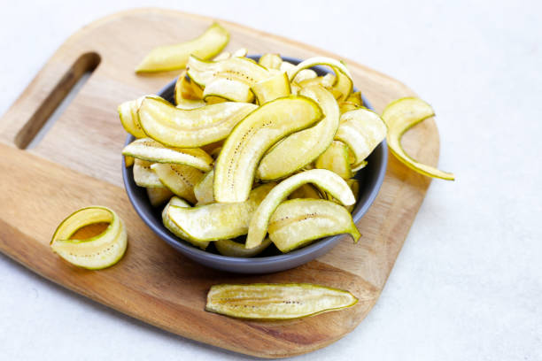 istock Banana chips, fried slices banana with green peel 2042796410