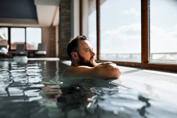 istock Side View Of Male Day Dreaming Inside Cool Swimming Pool Water 2042822576