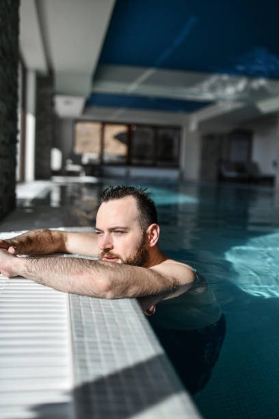 istock Handsome Male Contemplating Recent Decisions While Relaxing Inside Swimming Pool 2042827978