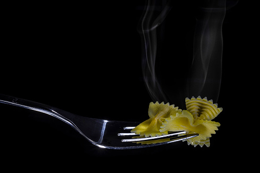 Cooked pasta on fork