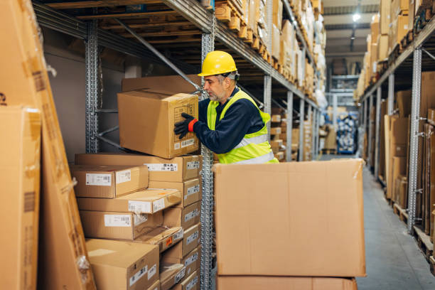 istock The warehouseman arranges boxes in the warehouse 2042838221